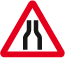 Road narrows on both sides